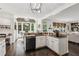 Modern kitchen flows into living room with stainless appliances, granite countertops, breakfast bar at 750 Highview Ct, Woodstock, GA 30189