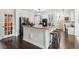 Modern kitchen features white cabinets, granite countertops, stainless steel appliances, and breakfast bar at 750 Highview Ct, Woodstock, GA 30189