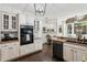 Modern kitchen with stainless steel appliances, granite countertops, built-in desk and natural light at 750 Highview Ct, Woodstock, GA 30189
