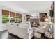 Cozy living room with built-in bookshelves, a stone fireplace, and large windows offering natural light at 750 Highview Ct, Woodstock, GA 30189