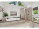 Luxurious bathroom with a soaking tub, glass shower, marble countertops, and tile floors at 750 Highview Ct, Woodstock, GA 30189