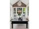 Cozy sitting room with vaulted ceiling, natural light, stylish decor, and hardwood accent wall at 750 Highview Ct, Woodstock, GA 30189