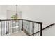 Elegant staircase features decorative iron railing, chandelier and ample natural light from window at 750 Highview Ct, Woodstock, GA 30189