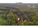 Scenic aerial view showcasing a lovely, wooded neighborhood with views of the mountains in the distance at 1496 Shadowrock Dr, Marietta, GA 30062