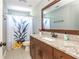 This bathroom is complete with a granite counter and a pineapple shower curtain at 1496 Shadowrock Dr, Marietta, GA 30062