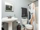 Bathroom with a pedestal sink, toilet, and shower/tub combo featuring a stylish shower curtain at 1496 Shadowrock Dr, Marietta, GA 30062
