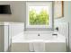This bathtub features a great view and neutral tile at 1496 Shadowrock Dr, Marietta, GA 30062