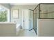 This well-lit bathroom features a glass shower, a soaking tub, and ample natural light at 1496 Shadowrock Dr, Marietta, GA 30062