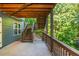 Under-deck patio with a cozy hammock chair and a stairway that leads up to the deck at 1496 Shadowrock Dr, Marietta, GA 30062