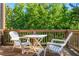 Outdoor deck with white seating offers relaxing views of the surrounding trees at 1496 Shadowrock Dr, Marietta, GA 30062