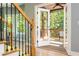 Staircase leads to an open porch featuring a ceiling fan and wooded backyard views at 1496 Shadowrock Dr, Marietta, GA 30062