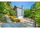 Charming home exterior featuring a two-car garage, lush landscaping, and a long driveway at 1496 Shadowrock Dr, Marietta, GA 30062