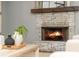 Stone fireplace with wooden mantel and burning fire at 1496 Shadowrock Dr, Marietta, GA 30062