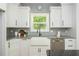 Kitchen featuring white cabinetry and a stainless steel dishwasher at 1496 Shadowrock Dr, Marietta, GA 30062