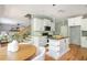 Open concept kitchen with white cabinets, kitchen island and living room at 1496 Shadowrock Dr, Marietta, GA 30062