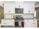 Modern kitchen with stainless steel appliances and stylish white backsplash at 1496 Shadowrock Dr, Marietta, GA 30062