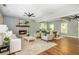 Open-concept living room and dining room featuring hardwood floors, stone fireplace and neutral color scheme at 1496 Shadowrock Dr, Marietta, GA 30062