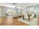 Open concept living room and dining area with hardwood floors, a stone fireplace, and ample natural light at 1496 Shadowrock Dr, Marietta, GA 30062