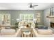 Well-lit living room featuring hardwood floors, a stone fireplace, neutral paint, and access to an outdoor deck at 1496 Shadowrock Dr, Marietta, GA 30062