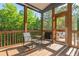 Comfortable screened porch with wood flooring offers relaxing views of the surrounding trees at 1496 Shadowrock Dr, Marietta, GA 30062