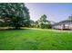 Spacious backyard with a well-maintained lawn, mature trees, and a charming deck, ideal for outdoor living at 2091 Moon Drive Sw, Conyers, GA 30094