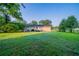 Well-kept backyard with lush lawn, mature trees, and a cozy deck, offering a serene outdoor escape at 2091 Moon Drive Sw, Conyers, GA 30094