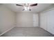 Neutral bedroom featuring soft carpet, a ceiling fan, and a spacious closet for ample storage at 2091 Moon Drive Sw, Conyers, GA 30094