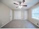 Bright bedroom with plush carpet, ceiling fan, and generous closet space at 2091 Moon Drive Sw, Conyers, GA 30094