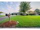 Charming single-story home featuring a lush green lawn, mature shade tree, and well-maintained landscaping at 2091 Moon Drive Sw, Conyers, GA 30094