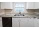 Bright kitchen featuring white cabinets, granite countertops, stainless steel sink and black dishwasher at 2091 Moon Drive Sw, Conyers, GA 30094