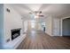 Inviting living room featuring a whitewashed brick fireplace, modern ceiling fan, and light brown floors at 2091 Moon Drive Sw, Conyers, GA 30094