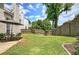 Spacious backyard featuring a lawn, patio, and privacy fence, ideal for outdoor living and entertaining at 2908 Cottesford Se Way, Smyrna, GA 30080