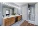 Bathroom with a double sink vanity, a large mirror with Hollywood lights, and a glass-door shower at 2908 Cottesford Se Way, Smyrna, GA 30080