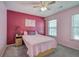 Bedroom featuring a pink color scheme, a bed with decorative pillows, and natural lighting at 2908 Cottesford Se Way, Smyrna, GA 30080