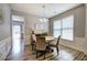 Dining room with wainscoting, window, and wood floors, adjacent to living area at 2908 Cottesford Se Way, Smyrna, GA 30080