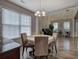 Dining room with large windows, wood floors and string lights above table at 2908 Cottesford Se Way, Smyrna, GA 30080