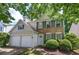 Charming two-story home with a manicured lawn, brick accents, gray shutters and a two-car garage at 2908 Cottesford Se Way, Smyrna, GA 30080