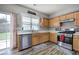 Kitchen features wood cabinets, stainless steel appliances, and backyard views at 2908 Cottesford Se Way, Smyrna, GA 30080