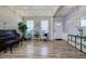 Open living room with string lights, hardwood floors, piano, and storage at 2908 Cottesford Se Way, Smyrna, GA 30080