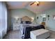 A well-lit main bedroom featuring neutral decor, a vaulted ceiling, and a large window at 2908 Cottesford Se Way, Smyrna, GA 30080