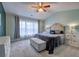 A well-lit main bedroom featuring neutral decor, a vaulted ceiling, and a large window at 2908 Cottesford Se Way, Smyrna, GA 30080