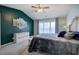 Stylish main bedroom featuring an accent wall, neutral decor, a vaulted ceiling, and a large window at 2908 Cottesford Se Way, Smyrna, GA 30080