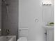 Modern bathroom features tiled shower, sink with vanity, and an illuminated mirror above the sink at 402 Roswell Green Ln, Roswell, GA 30075