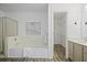 A spacious bathroom features a soaking tub with tile surround, glass shower doors, and a closet at 402 Roswell Green Ln, Roswell, GA 30075