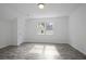 Bright bedroom features wood-look floors and a sunny window view at 402 Roswell Green Ln, Roswell, GA 30075