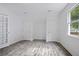 Bedroom boasts wood-look flooring and two closets, providing ample storage at 402 Roswell Green Ln, Roswell, GA 30075
