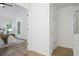 Comfortable bedroom features a vaulted ceiling, windows overlooking a wooded area, and an attached bathroom at 402 Roswell Green Ln, Roswell, GA 30075
