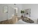 Bright bedroom boasts wood floors, white walls, and French doors leading to the ensuite bathroom at 402 Roswell Green Ln, Roswell, GA 30075