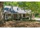 Charming front exterior with brick facade and lovely landscaping at 402 Roswell Green Ln, Roswell, GA 30075