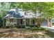 Charming brick home with a well-manicured lawn and attached garage at 402 Roswell Green Ln, Roswell, GA 30075